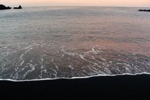 Visit a black sand beach